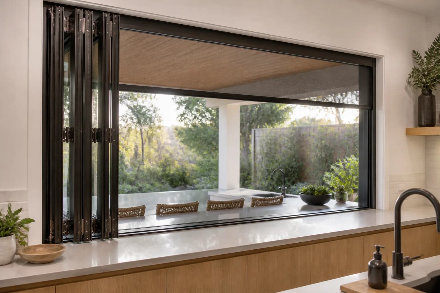 Folding kitchen pass-through window above a continuous counter